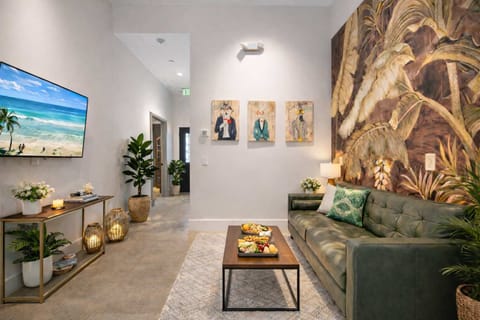 Stylish Lounge Area with Tropical Wall Art, Cozy Seating & Warm Ambient Lighting Creating a Relaxed Resort Vibe