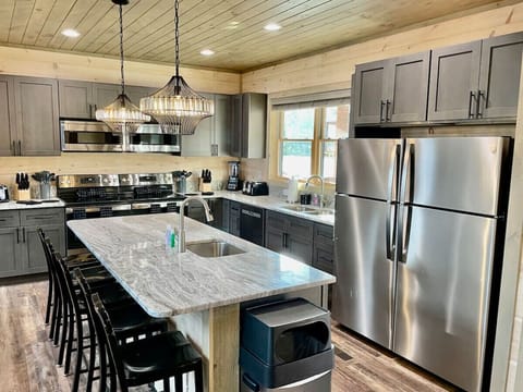 The fully-equipped kitchen has 2 fridges, 2 stoves, 2 microwaves & 2 dishwashers.