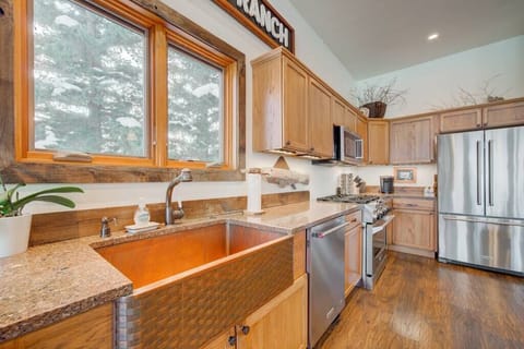 The large kitchen includes stainless appliances, copper sink and granite countertops. 