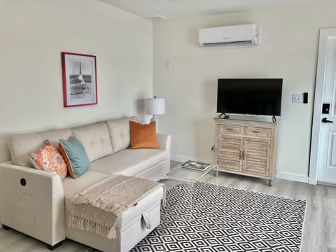 Newly furnished living room with sleeper sectional overlooking the water