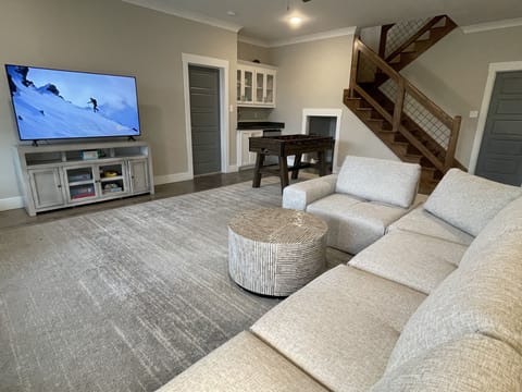 Downstairs den/playroom/game room with foosball table.