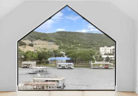 View of your VRBO from across the cove (Your VRBO and boatdock have a blue roof)