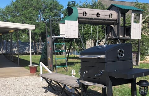 Small BBQ and Patio Play Area (note small lake view between lakehouses in back)