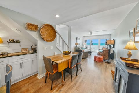 Step into your bright coastal haven where ocean views frame every meal and conversation flows from kitchen to living space.