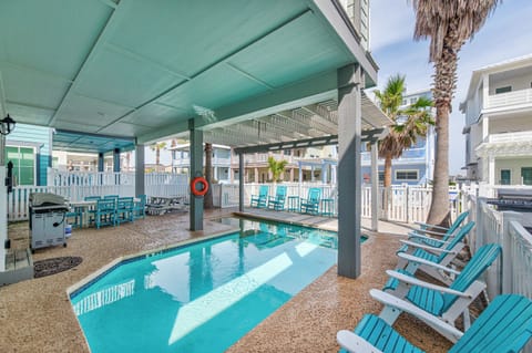 Your private pool oasis awaits with turquoise waters, covered seating, and tropical palms creating the perfect backdrop for relaxation.