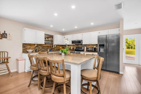 The kitchen is a chef's dream to cook in. It includes stainless steel appliances, quartz countertops, and a large counter top with 5 comfortable counter stools for additional eating space.