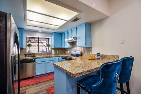 Large kitchen with plenty of dish wear and cooking amenities. 