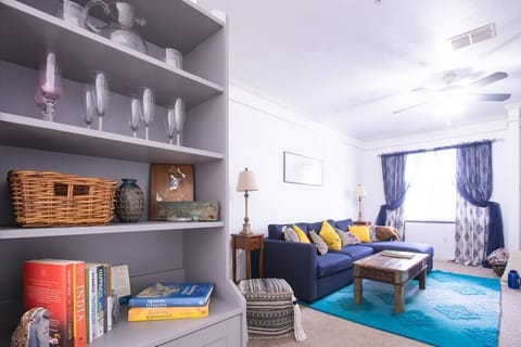 Curl up with a book or enjoy games in this stylish lounge area with shelves full of charm.