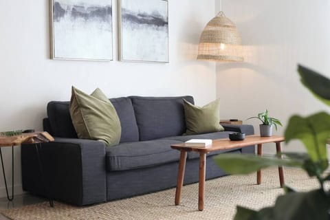 Chill out in the living room with a plush couch, warm lighting, and thoughtful decor that feels just like home.