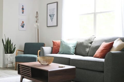Cozy up in the bright and modern living room, complete with comfy seating, stylish decor, and plenty of natural light.