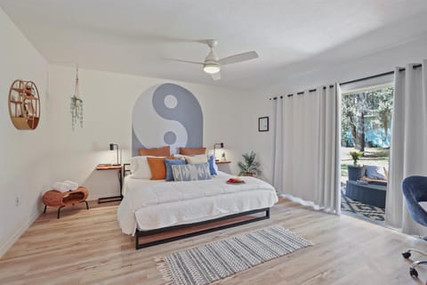 Modern Zen Sanctuary with Private Garden Access Find your balance in this thoughtfully curated bedroom featuring a custom Yin-Yang mural and minimalist design.
