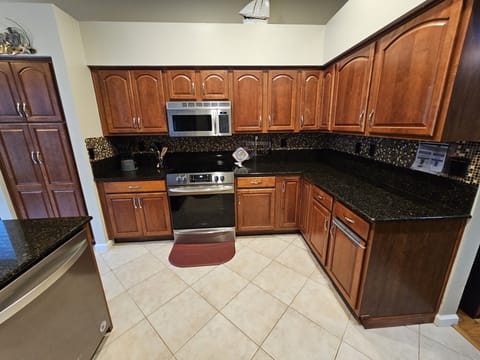 Kitchen stove / oven - some paper plates, cups, towels, dish soap, etc