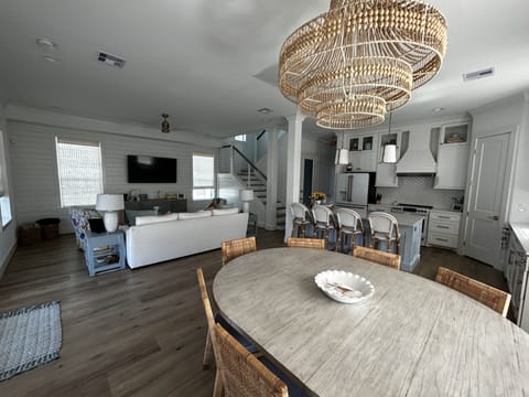 The living room, dining area and kitchen are all open with views of water.