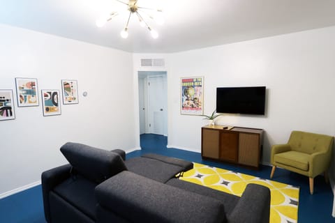 The space-age themed living room features an electric reclining sofa for two.