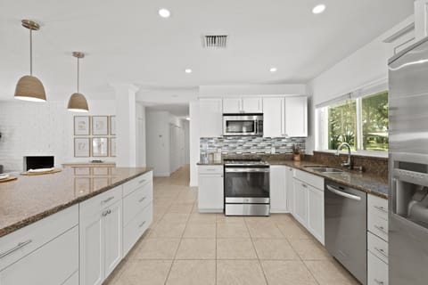 The open concept kitchen is fully equipped for all your home cooking needs.