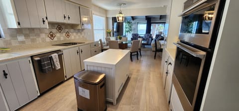Kitchen with breakfast area opening to large living area
