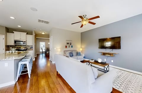 Open-concept living room with cozy seating and Smart TV