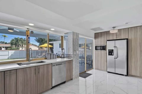 Cook with ease and enjoy poolside views in this bright, modern kitchen 🌴 Featuring stainless steel appliances, natural light, and tropical scenery, this vacation rental is perfect for family vacations, group getaways, or long-term stays.