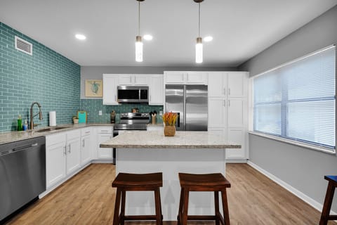 Kitchen island with extra sitting spaces and a comfortable cooking area