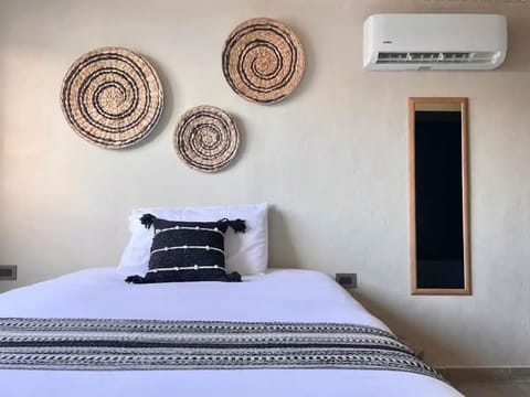 Comfortable double bed in a bright, modern studio