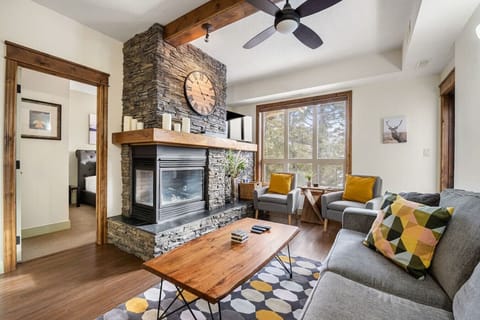 Living room with a gas fireplace, Smart TV, pull-out couch & access to the private patio
