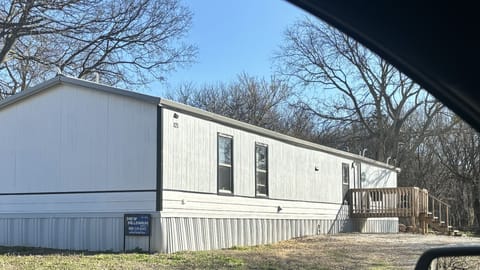 Exterior of property; large lot with gravel driveway, firepit, RV pad
