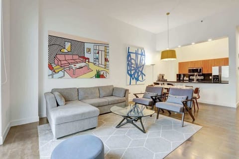 Spacious open concept interior featuring a living area with sofa bed, cozy dining area, and a fully equipped kitchen.