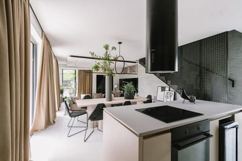 Modern air conditioned interior of the bright ground floor with fully equipped kitchen, a dining area and internal staircase in the new pet friendly holiday home - villa Noir Vodice