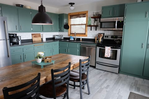 A large eat-in kitchen combines modern convenience with rustic charm.