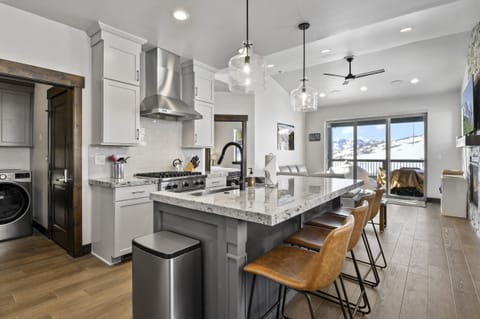 Gather in the bright and spacious chef's kitchen featuring premium appliances, a large island, and beautiful mountain views just beyond the windows.