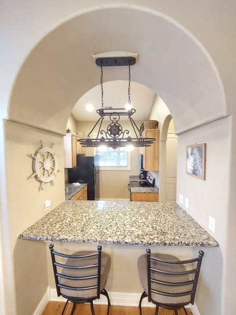 Breakfast bar, tall chairs, gorgeous lighting and decor!