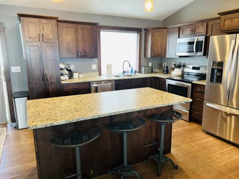 Kitchen and island for extra seating.