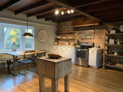 Updated kitchen with gorgeous brick wall,wooden beam ceiling and bay window 