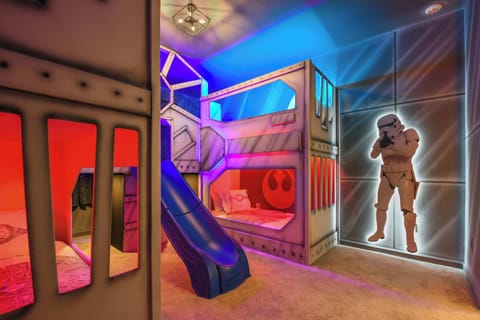 Experience an intergalactic adventure in this Star Wars-themed room featuring bunk beds with a slide and life-sized Stormtroopers.