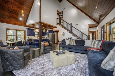White Tail Retreat has spacious open-concept living, dining, and kitchen area with cozy gas fireplace and large Roku TV.