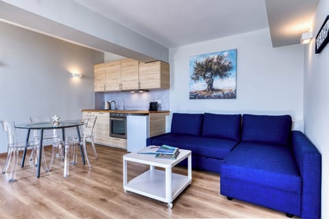 Inside you will find an open plan kitchenette, dining table, and a sofa-bed