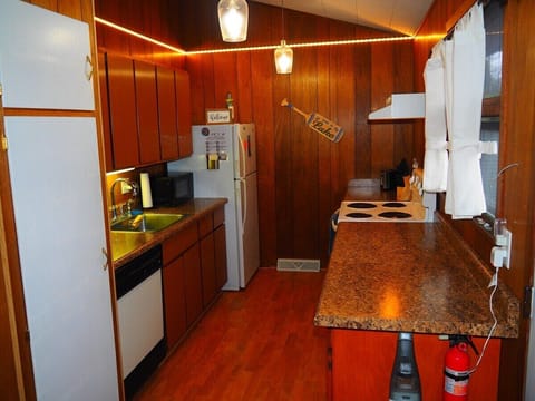 KITCHEN:  Very convenient and functional galley kitchen with all appliances, including a dishwasher.  Includes lots of counter space and a good supply of cooking and dining utensils.