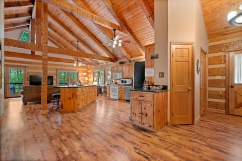 View of front door  right, open kitchen and living areas
. Cathedral ceilings. 