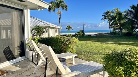 Outdoor private patio with two sun loungers overlooking the ocean.