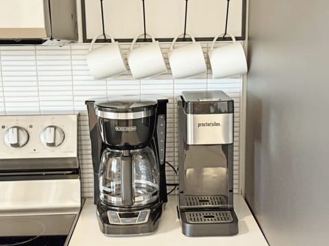 Multiple coffee makers and an electric kettle for your hot beverage preferences.