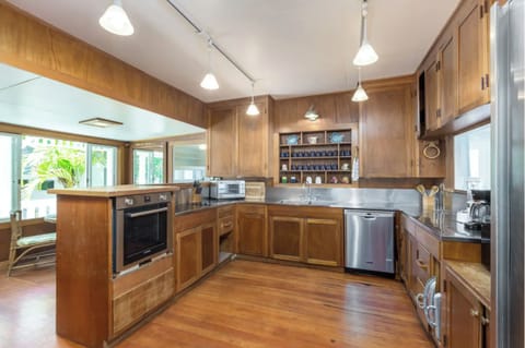 Kitchen with two large refrigerators, breakfast table.