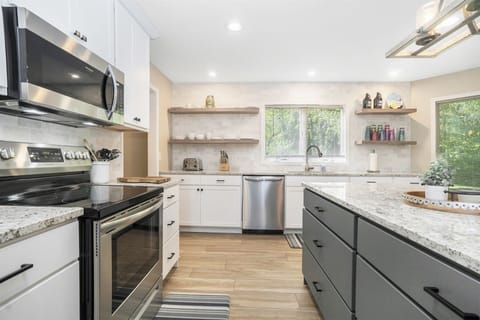 The fully equipped kitchen features stainless steel appliances