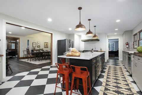 Fully equipped kitchen has casual seating at the center island
