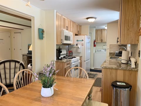 Kitchen has a range, microwave, Keurig, and toaster oven