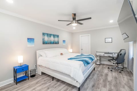 The master Bedroom has a king bed, 75 inch tv, a working desk, printer, an onsuite & a crib.