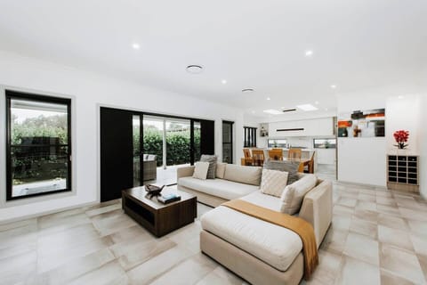 The spacious lounge area seamlessly flows out to the undercover patio and grassy backyard.