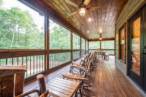 Large screen porch with rocking chairs & dining table for everyone.