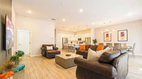 Bright and airy living space with modern furnishings, ideal for relaxation and social gatherings. Open layout connects seamlessly to the kitchen and dining area.