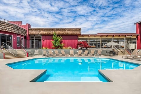 Dive into sunny relaxation with sparkling pool and loungers.