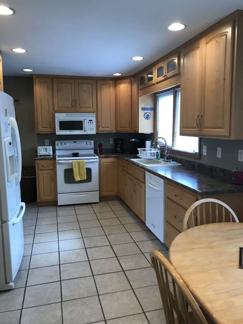 Kitchen with full stove and refrigerator